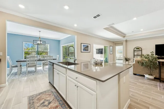 a kitchen with center island table and chairs