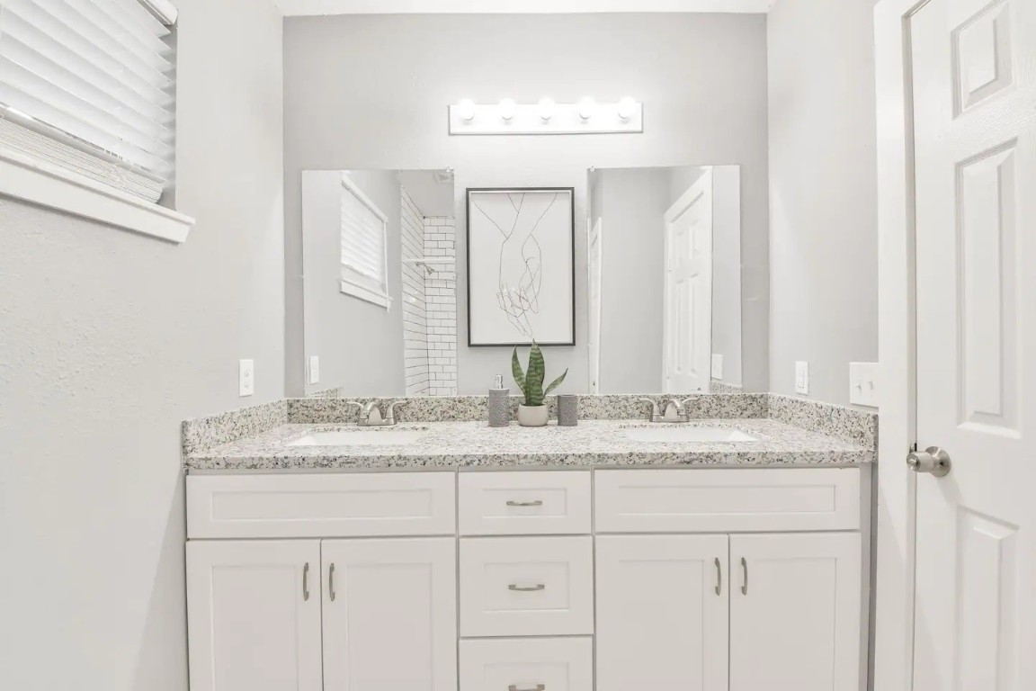 1212 Hamblen Street Houston, TX 77009 - Photo 11 of 13 a bathroom with a granite countertop sink and a mirror