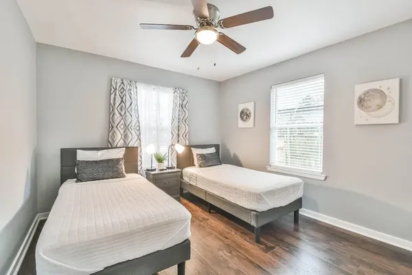 a bedroom with two beds and a window