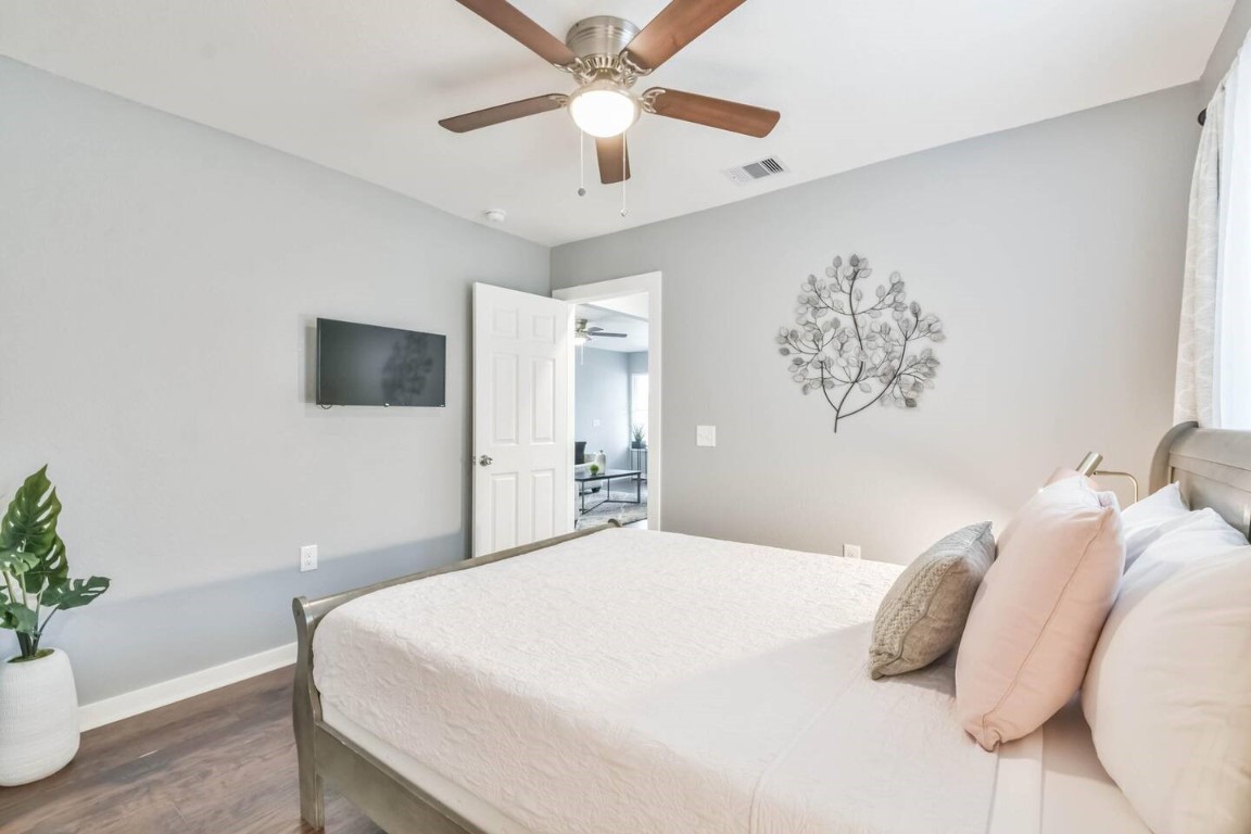1212 Hamblen Street Houston, TX 77009 - Photo 7 of 13 a bedroom with a large bed and a chandelier