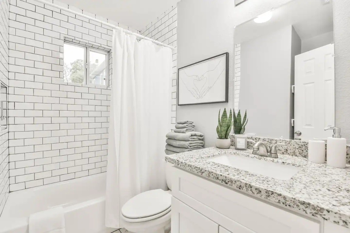 1212 Hamblen Street Houston, TX 77009 - Photo 8 of 13 a bathroom with a granite countertop sink toilet and shower