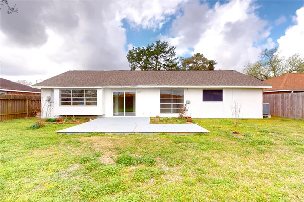 a front view of a house with a garden and trees