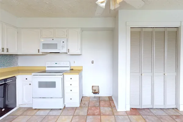 a utility room with cabinets washer and dryer