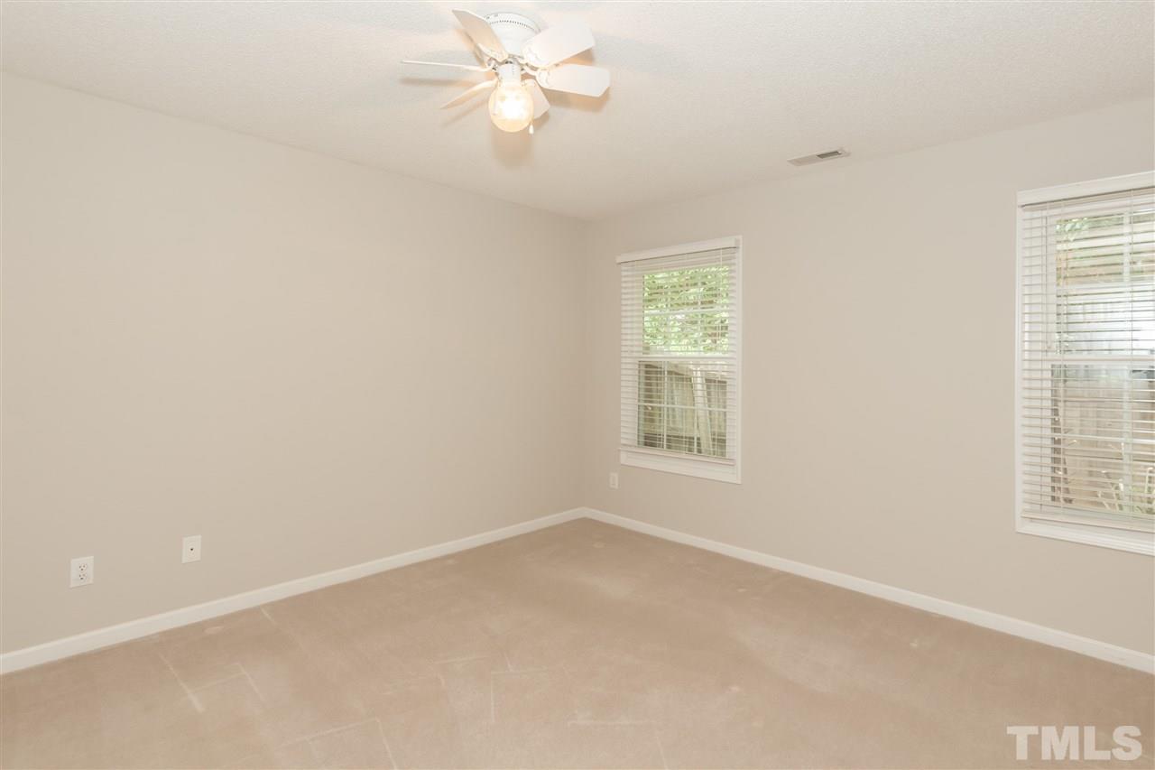 9000 Shallcross Way Raleigh, NC 27617 - Photo 11 of 25 an empty room with a window and a fan