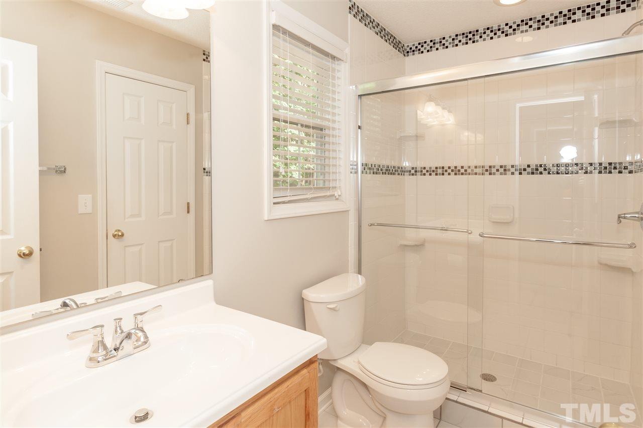 9000 Shallcross Way Raleigh, NC 27617 - Photo 12 of 25 a bathroom with a granite countertop sink a toilet and shower