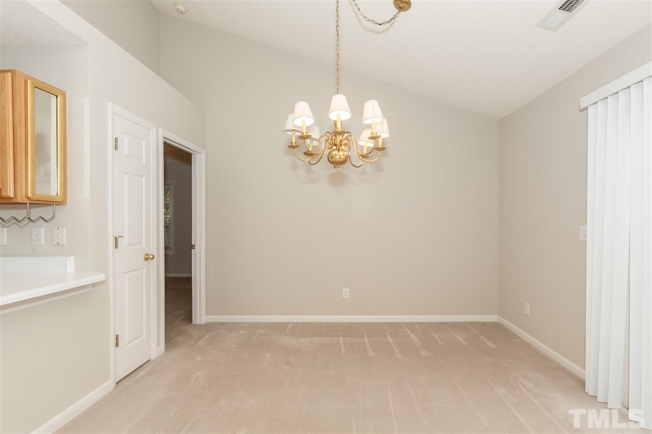 9000 Shallcross Way Raleigh, NC 27617 - Photo 15 of 25 a dining room with chandelier and window