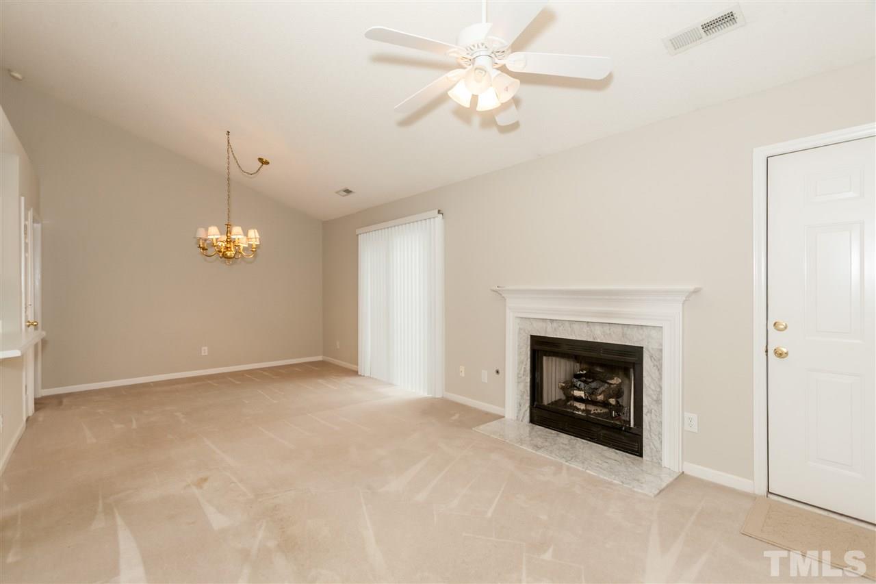 9000 Shallcross Way Raleigh, NC 27617 - Photo 17 of 25 an empty room with windows fireplace and fan