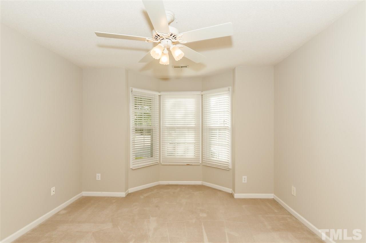 9000 Shallcross Way Raleigh, NC 27617 - Photo 19 of 25 an empty room with windows and fan