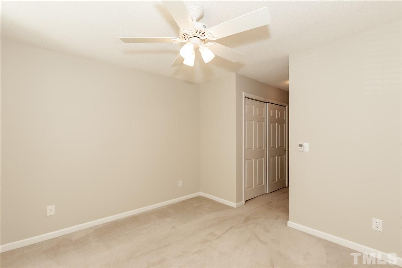 9000 Shallcross Way Raleigh, NC 27617 - Photo 20 of 25 an empty room with a ceiling fan and a window