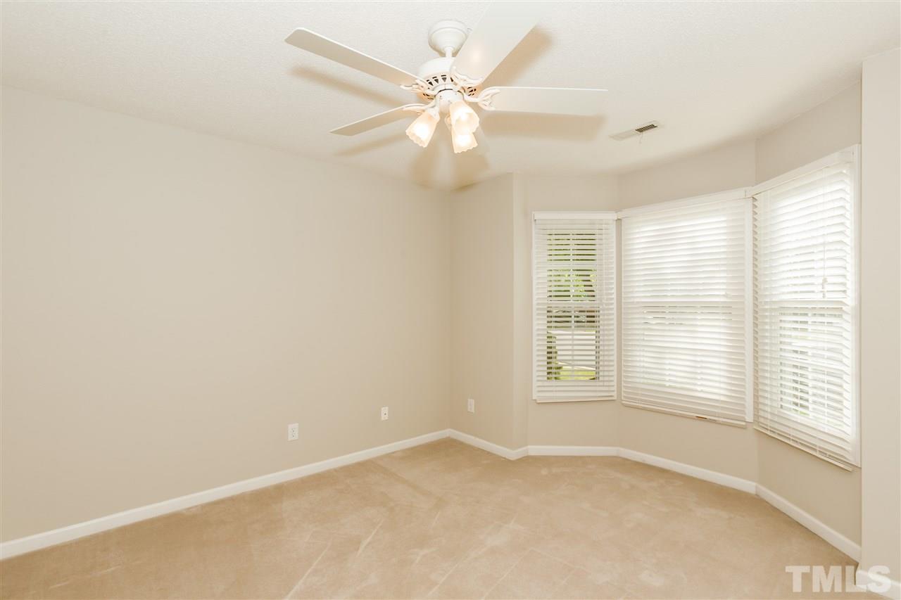 9000 Shallcross Way Raleigh, NC 27617 - Photo 21 of 25 an empty room with windows and ceiling fan