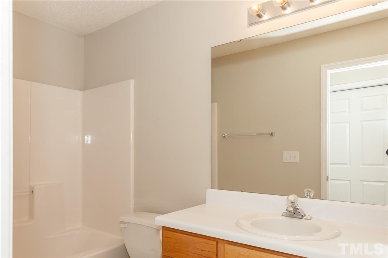 9000 Shallcross Way Raleigh, NC 27617 - Photo 22 of 25 a bathroom with a sink and a mirror