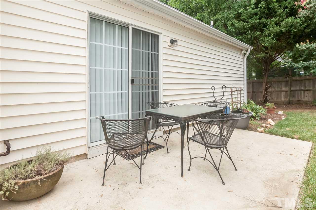 9000 Shallcross Way Raleigh, NC 27617 - Photo 4 of 25 a view of a chairs and tables in the back yard of the house