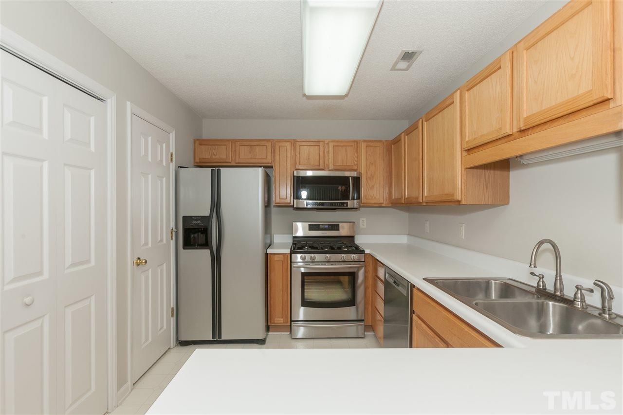 9000 Shallcross Way Raleigh, NC 27617 - Photo 5 of 25 a kitchen with stainless steel appliances granite countertop a refrigerator sink and stove