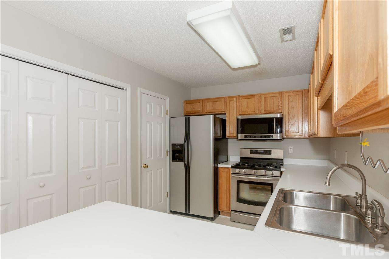 9000 Shallcross Way Raleigh, NC 27617 - Photo 7 of 25 a kitchen with stainless steel appliances a refrigerator a stove a microwave and cabinets