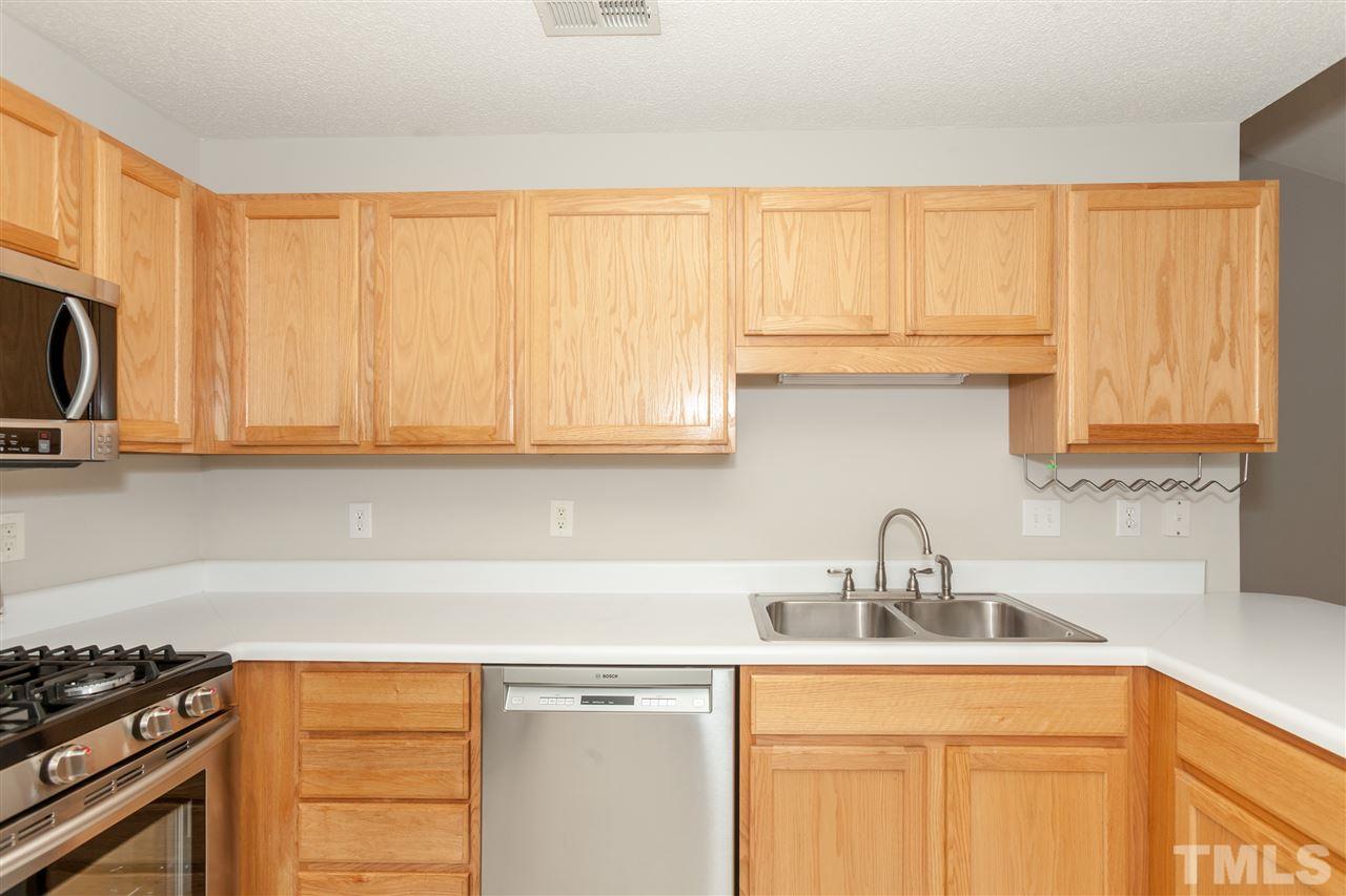 9000 Shallcross Way Raleigh, NC 27617 - Photo 8 of 25 a kitchen with stainless steel appliances granite countertop a sink a stove and a microwave