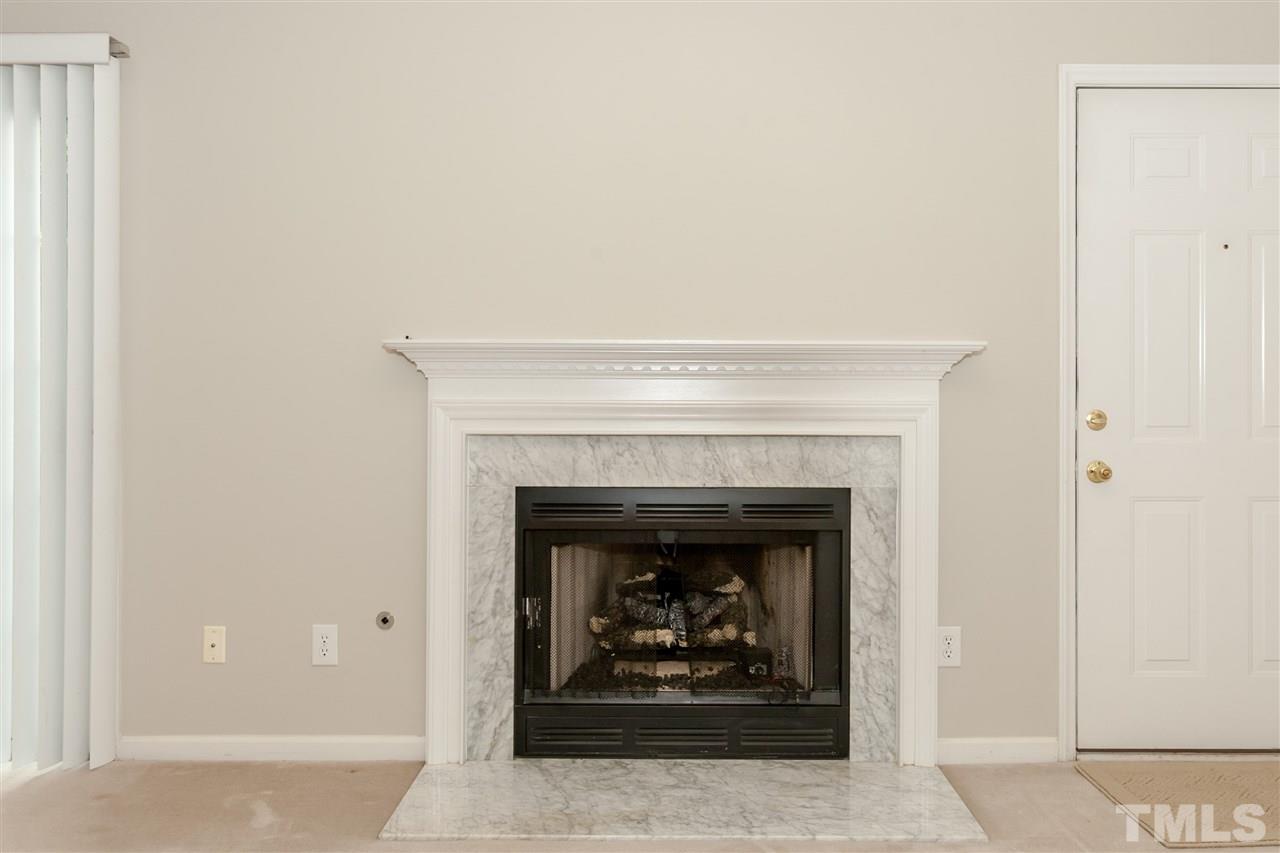 9000 Shallcross Way Raleigh, NC 27617 - Photo 9 of 25 a living room with a fireplace