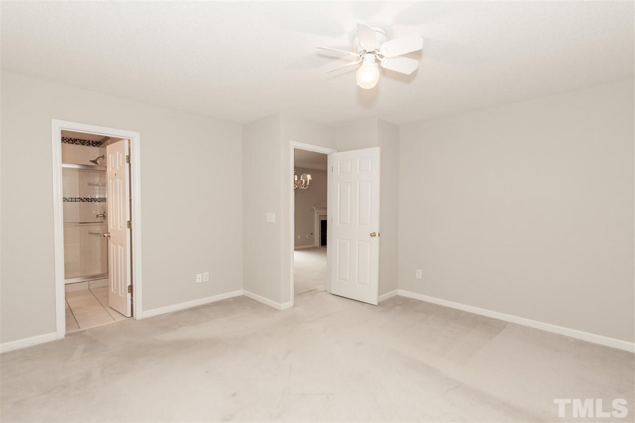 9000 Shallcross Way Raleigh, NC 27617 - Photo 10 of 25 an empty room with a ceiling fan and a window