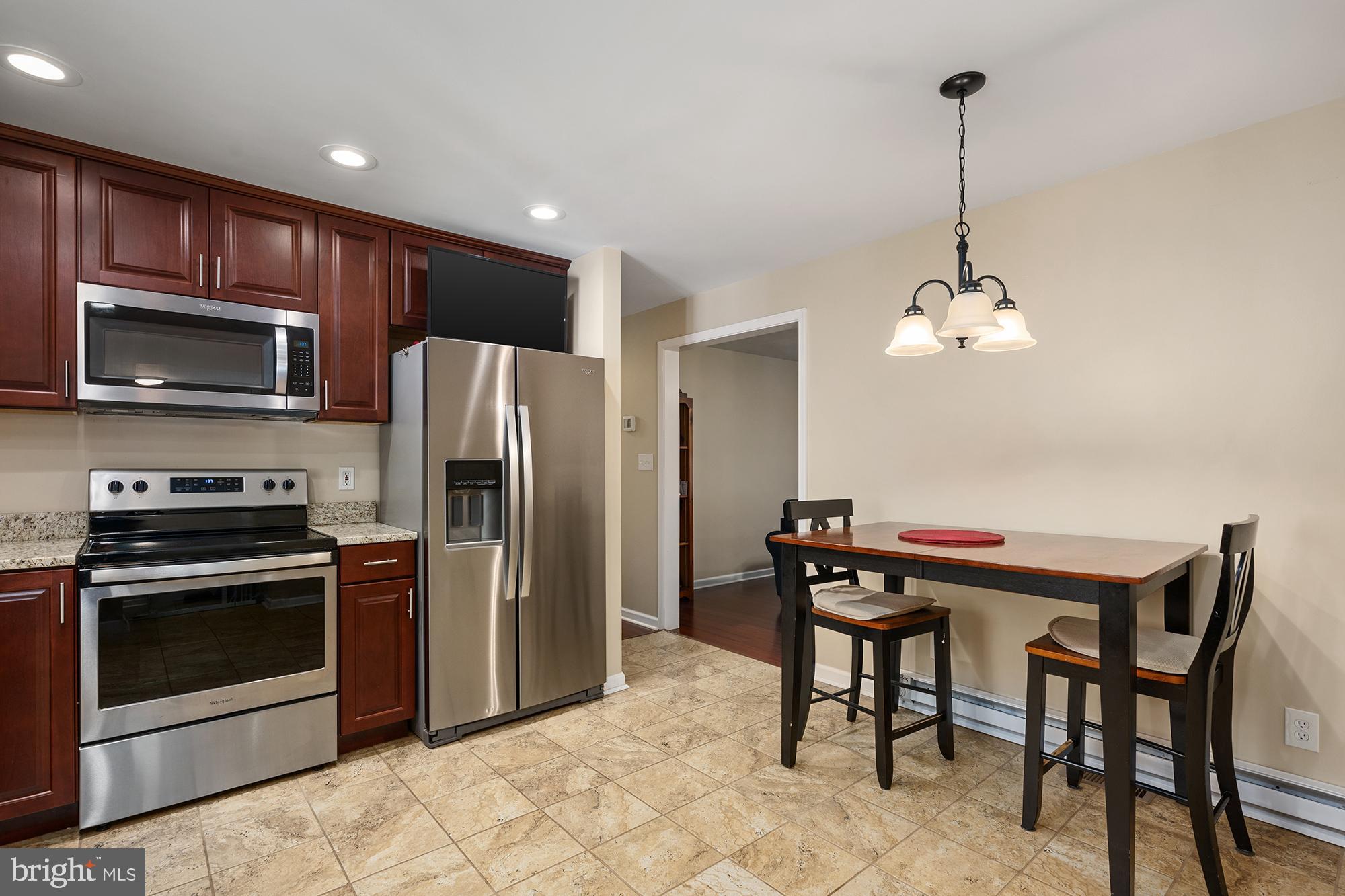 4010 Greenmount Church Road Hampstead, MD 21074 - Photo 13 of 32 a kitchen with a table and refrigerator