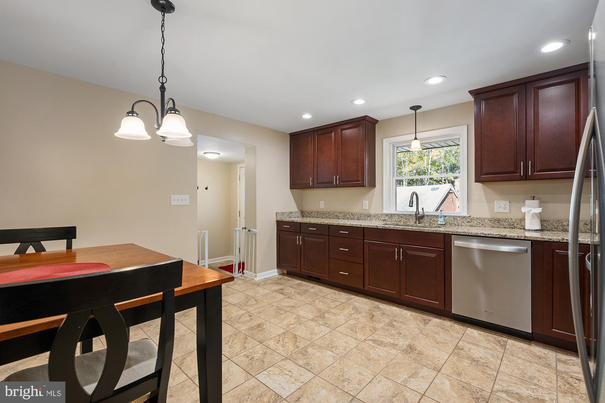 4010 Greenmount Church Road Hampstead, MD 21074 - Photo 14 of 32 a kitchen with stainless steel appliances granite countertop a sink dishwasher a stove a refrigerator with a dining table and chairs