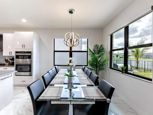 a kitchen with granite countertop kitchen island wooden cabinets stainless steel appliances and sink