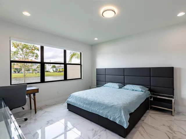a bedroom with a large bed and a window