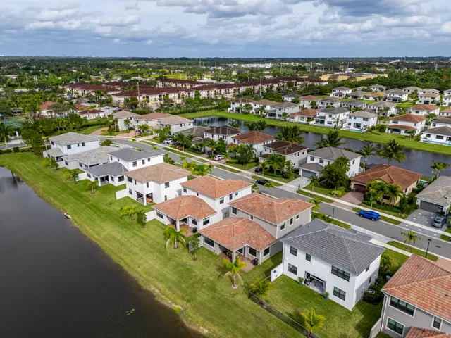an aerial view of residential houses with outdoor space and river