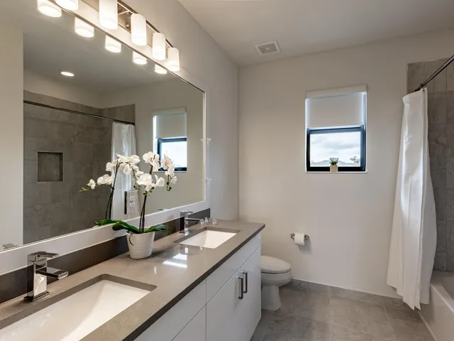 a bathroom with a double vanity sink and a mirror