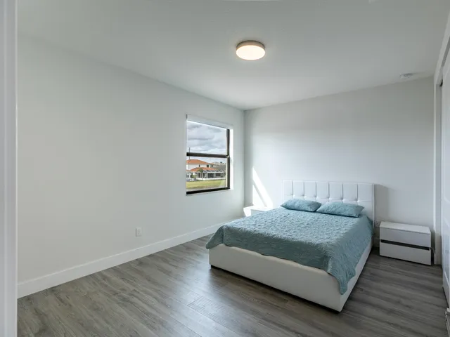 a bedroom with a bed and a desk