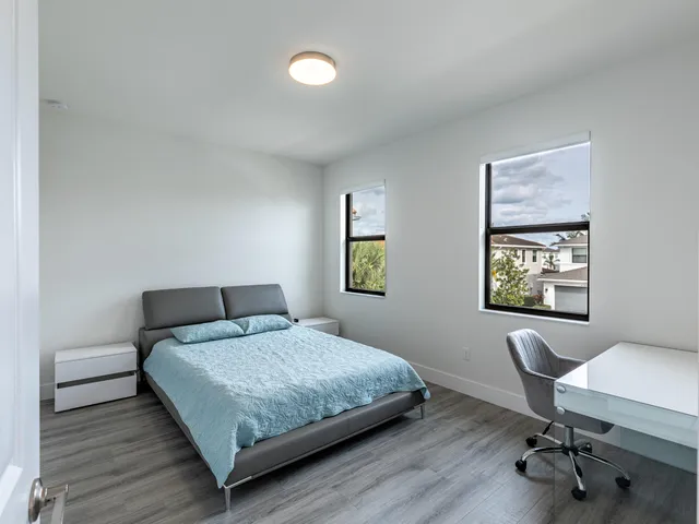 a bedroom with a bed and a desk