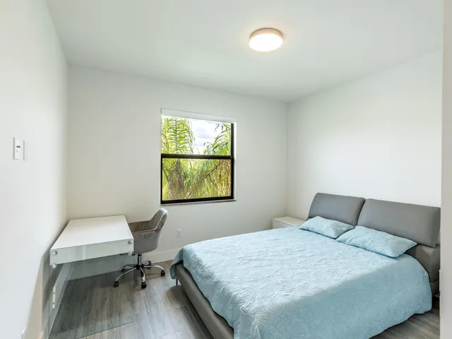 a bathroom with a granite countertop sink a toilet and shower