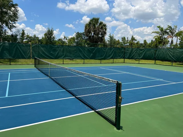 a swimming pool with outdoor seating and trees