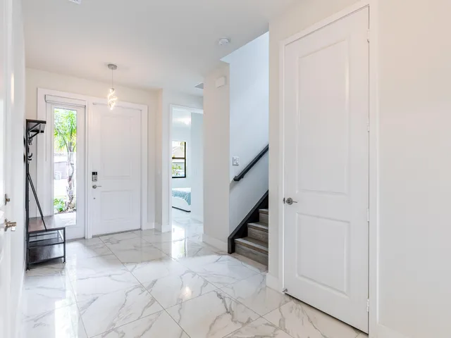 a view of entryway with wooden floor and livingroom