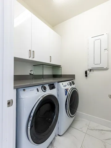 a living room with fireplace furniture and a large window