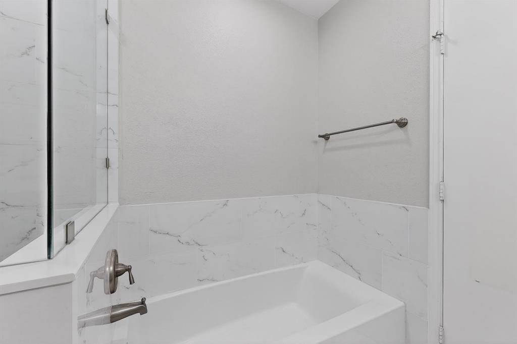 7729 Misty Ridge Drive North Fort Worth, TX 76137 - Photo 16 of 30 a bathroom with a bathtub