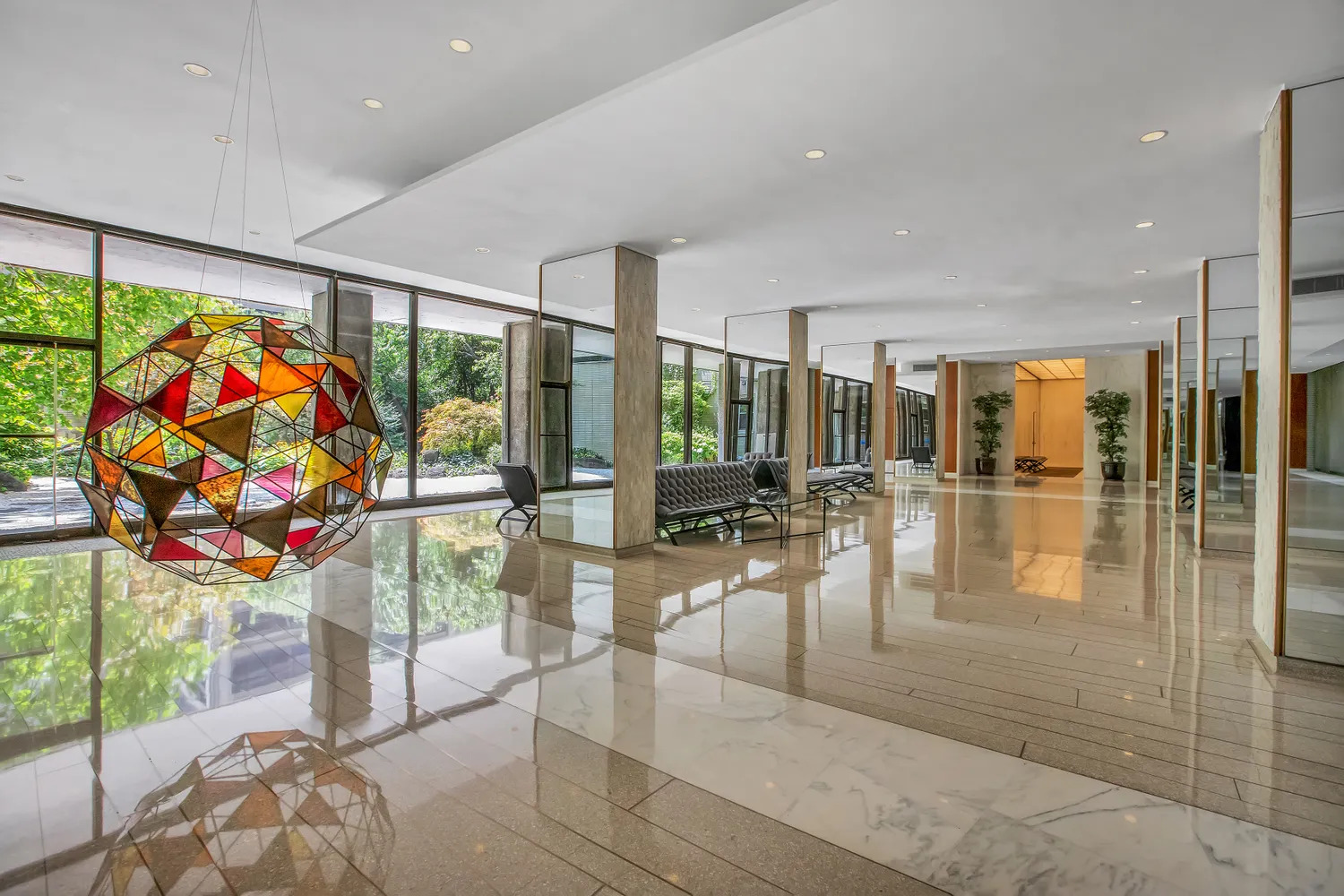 150 East 69th Street, Unit 19N Manhattan, NY 10021 - Photo 11 of 15 a view of a hallway with dining area and chandelier