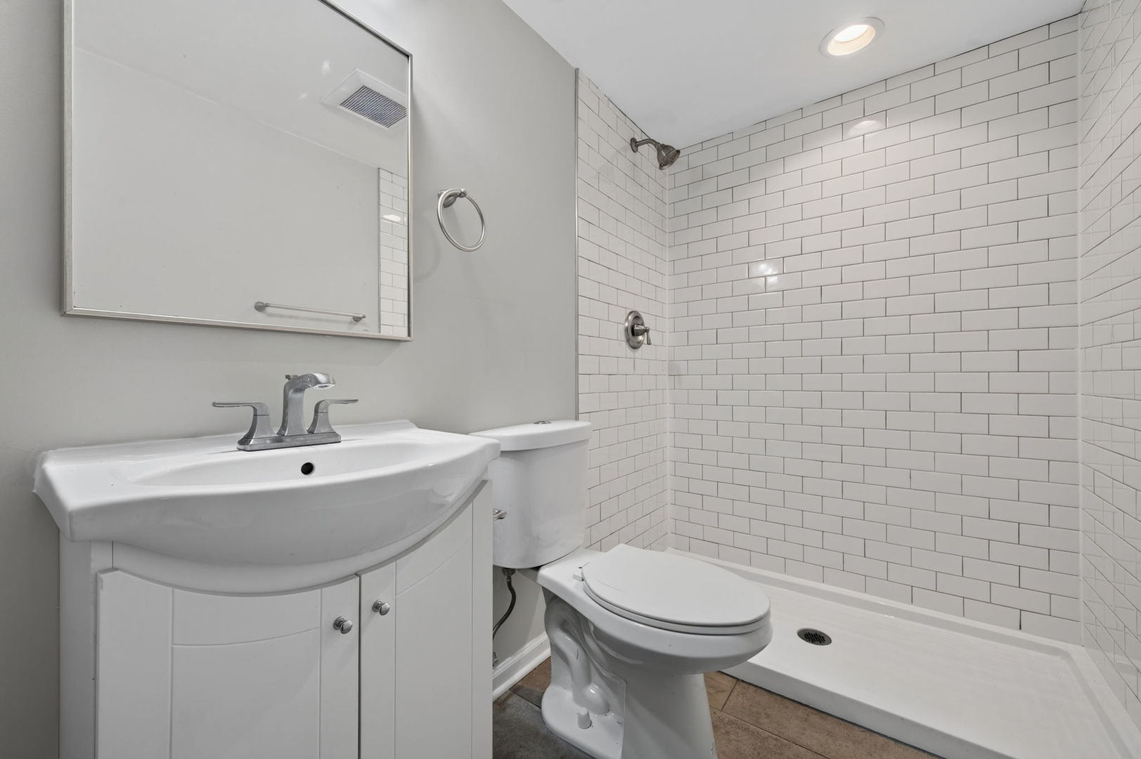 415 Alma Terrace Cary, IL 60013 - Photo 18 of 23 a bathroom with a sink a toilet and shower
