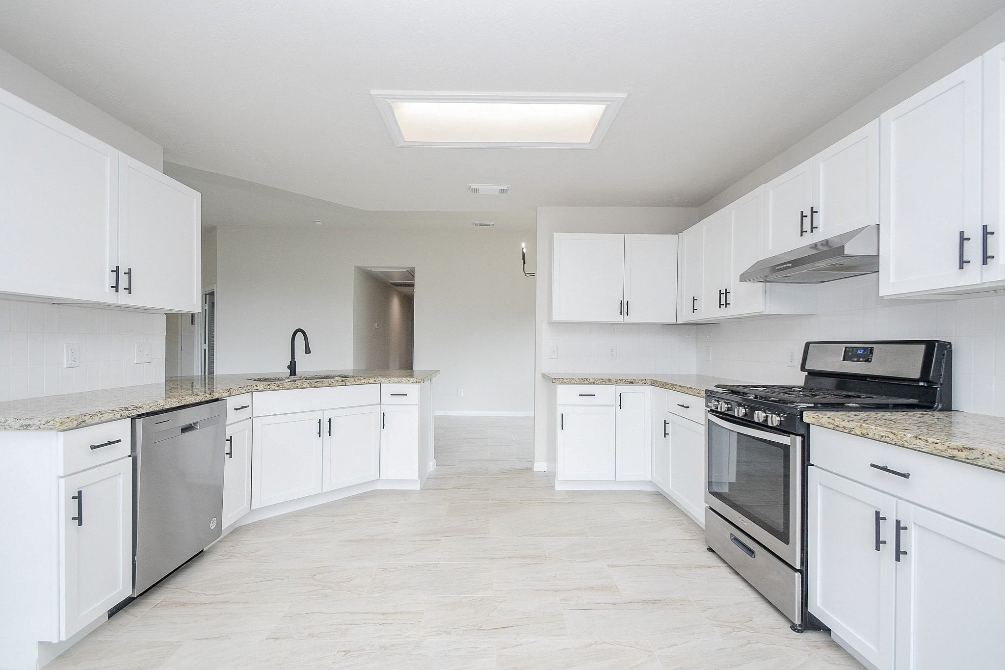 1422 Township Court Rosenberg, TX 77471 - Photo 15 of 32 a kitchen with granite countertop white cabinets and stainless steel appliances