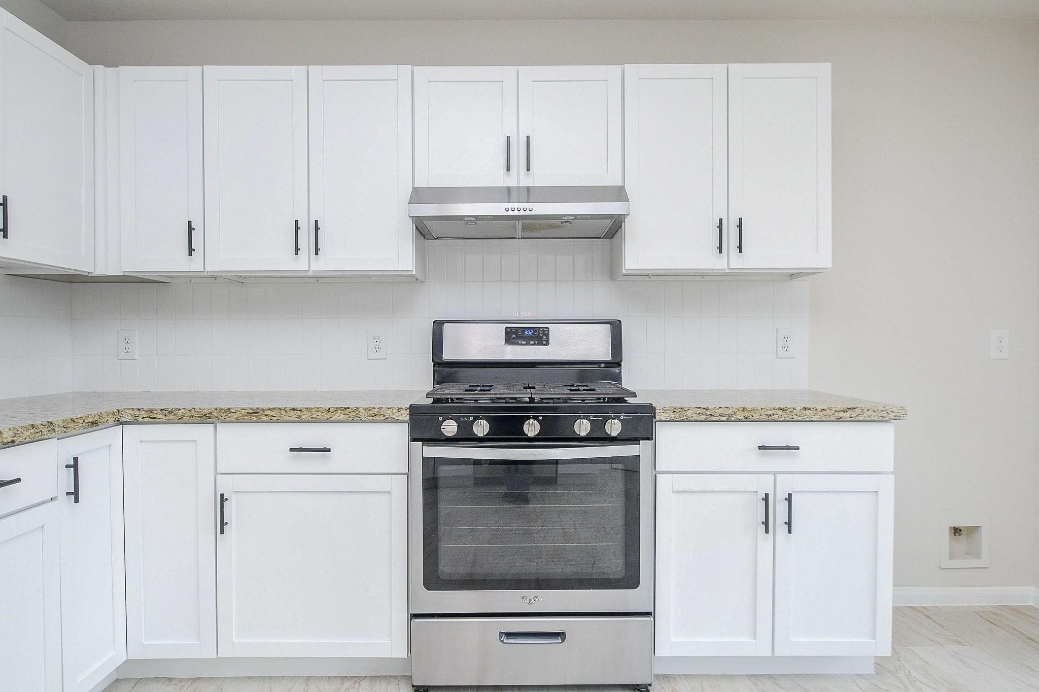 1422 Township Court Rosenberg, TX 77471 - Photo 17 of 32 a kitchen with granite countertop white cabinets and white stove