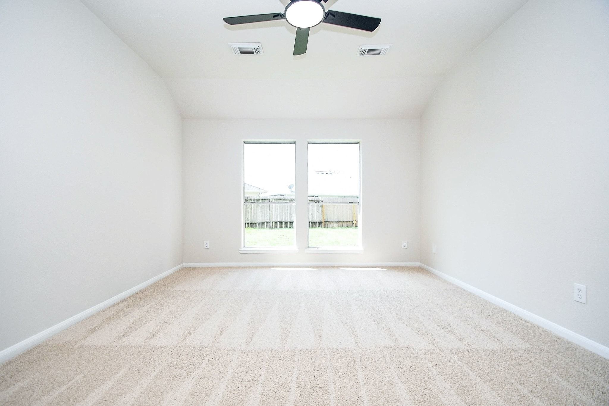 1422 Township Court Rosenberg, TX 77471 - Photo 25 of 32 an empty room with windows and fan
