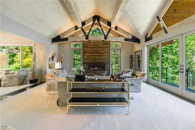 a living room with patio furniture and a large window