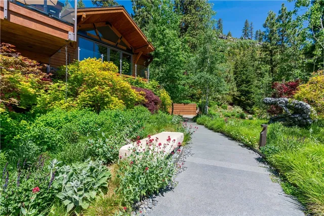 a backyard of a house with a yard and outdoor seating