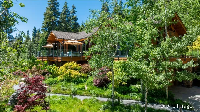 an aerial view of a house with swimming pool and garden