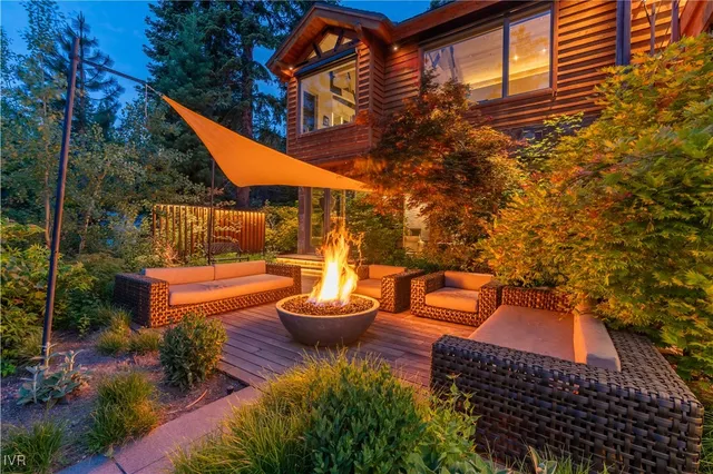 an aerial view of a house with a yard and large trees