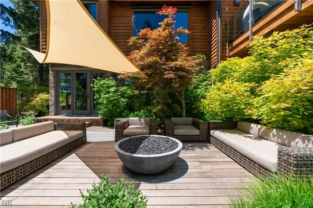 a view of a patio with couches table and chairs and potted plants