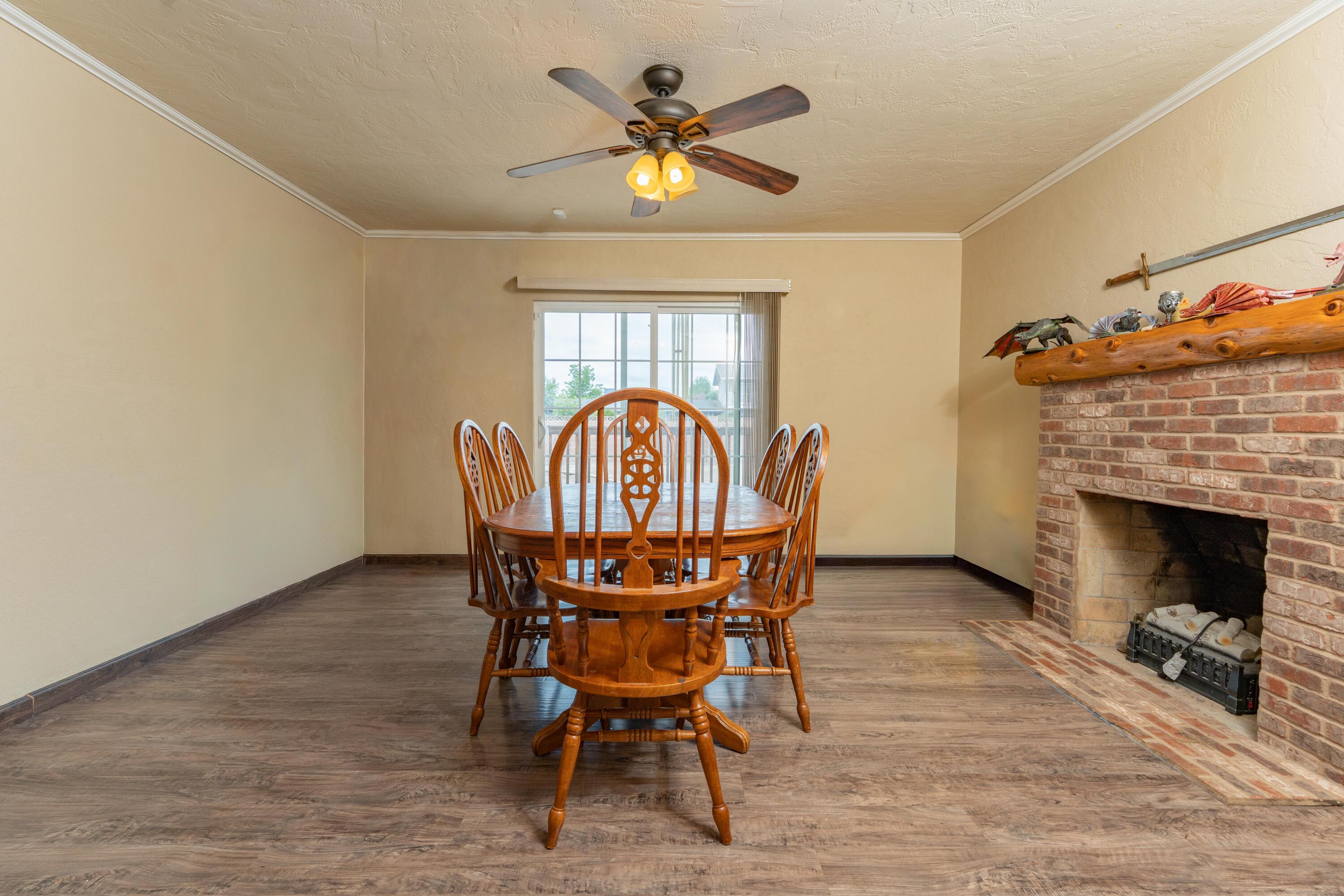 570 North Birch Avenue Reedley, CA 93654 - Photo 19 of 52 a view of a dining room with furniture and a fireplace