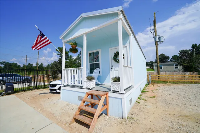 a living room with furniture and a lamp