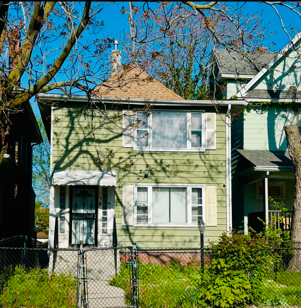 19 South Waller Avenue Chicago, IL 60644 - Photo 1 of 16 a front view of a house with a garden
