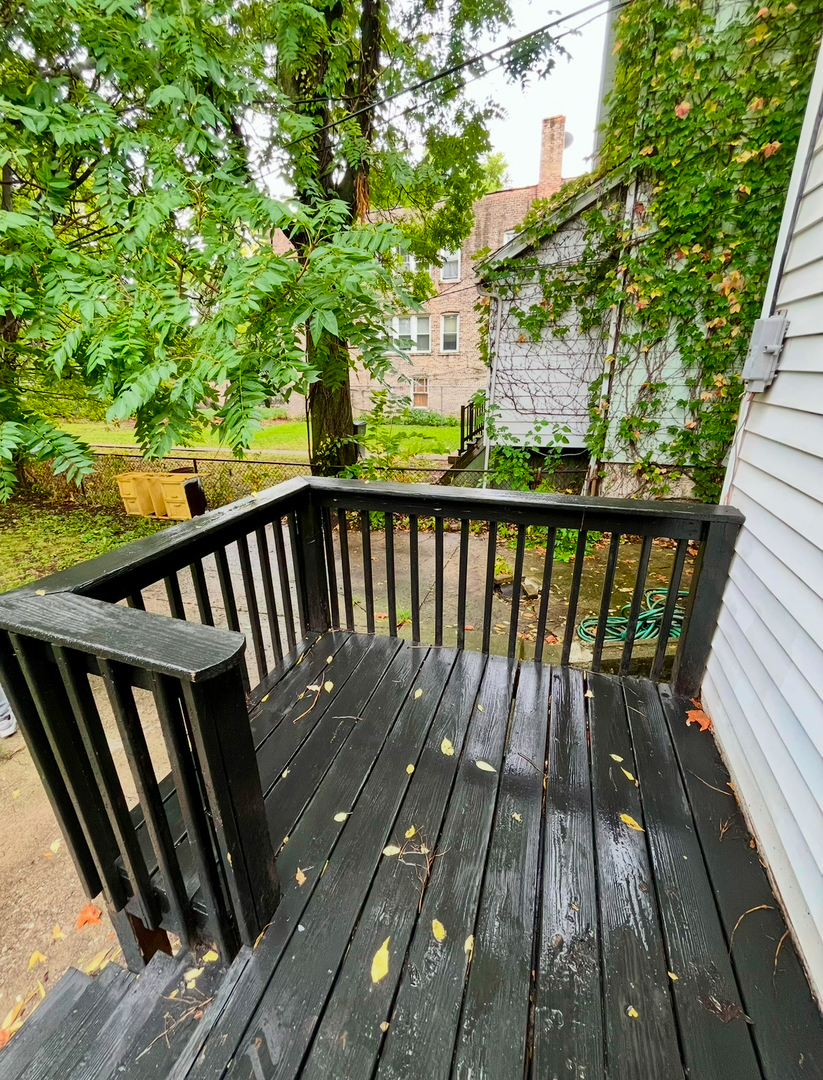 19 South Waller Avenue Chicago, IL 60644 - Photo 15 of 16 a view of balcony with wooden floor and fence