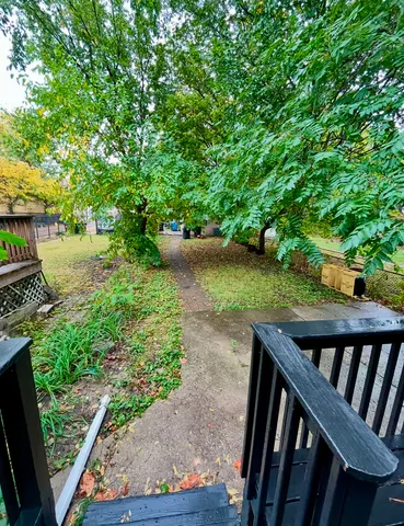 a view of a wooden deck with chairs and a yard