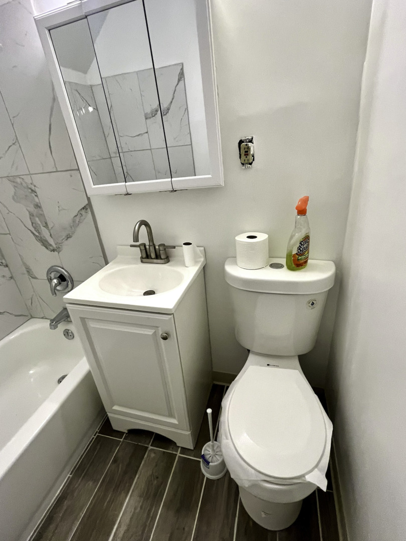 19 South Waller Avenue Chicago, IL 60644 - Photo 2 of 16 a bathroom with a sink toilet and a bathtub
